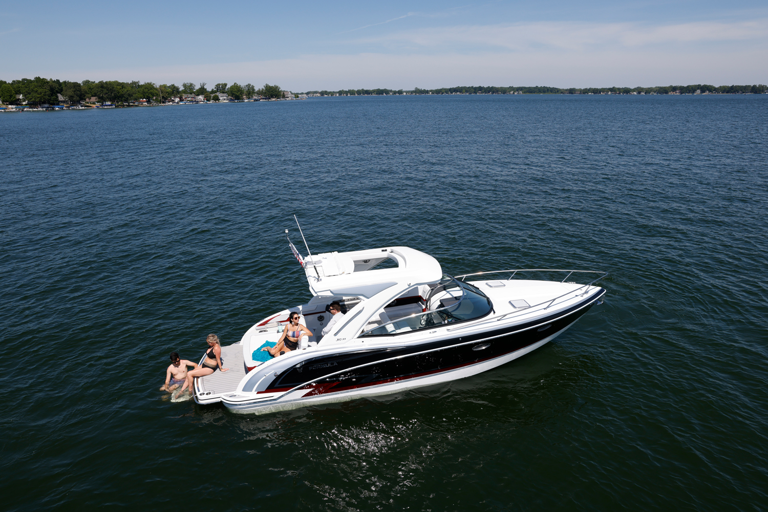 a group of people are sitting on the back of a boat