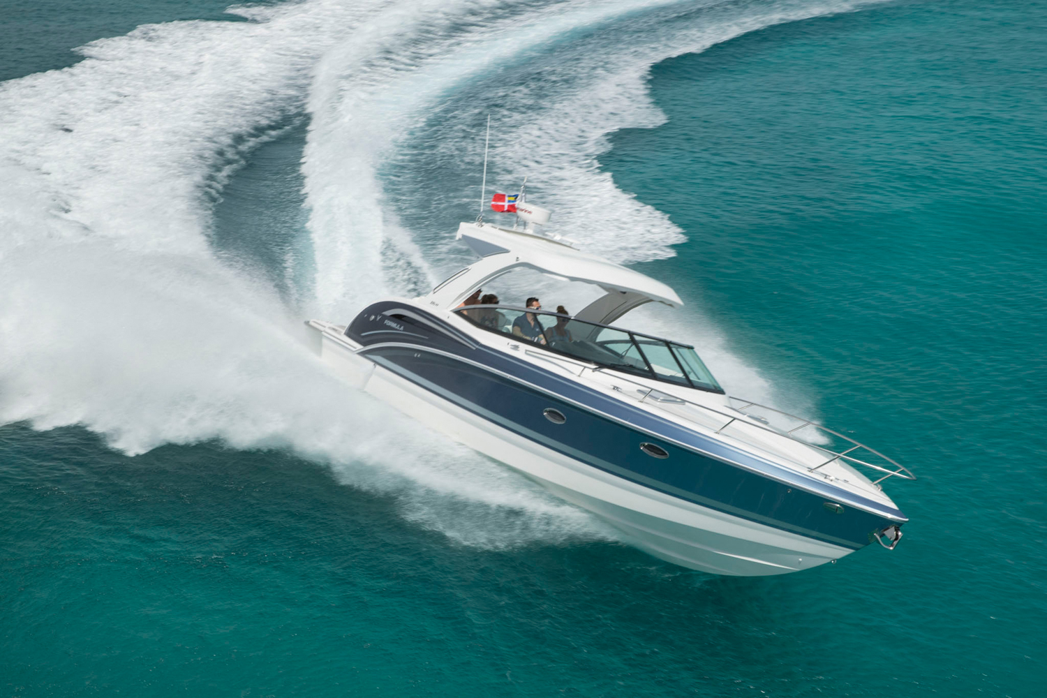 a blue and white boat is going through the ocean