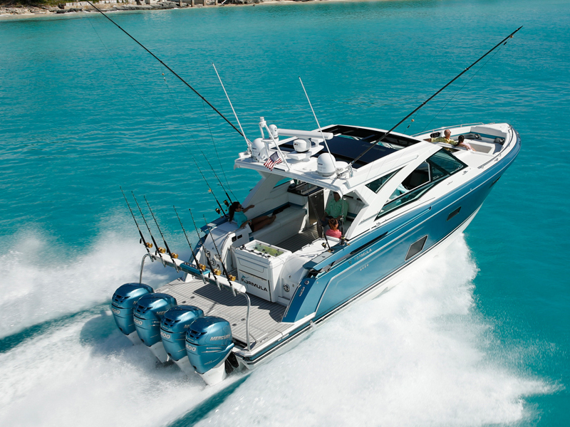 a blue and white speed boat with the word Formula on the side