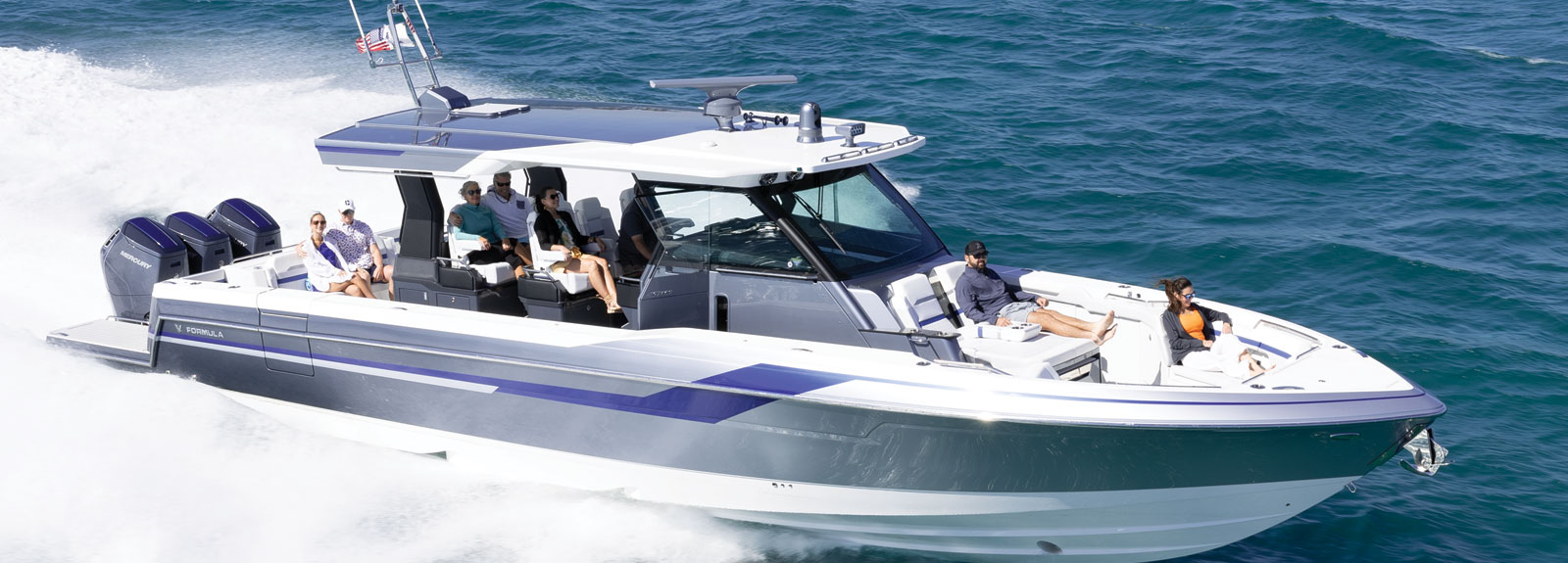 a gray and white boat with the word tornado on the side